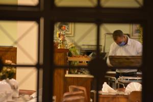 a chef standing in a kitchen preparing food at City Tower Hotel in Aqaba