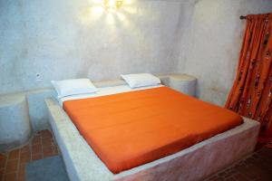 
A bed or beds in a room at Ecolodge de Palmarin
