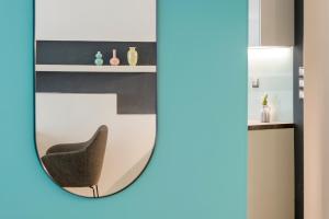 a mirror image of a chair in a room at Ioannina In - central & modern apt 36m2 lake view in Ioannina