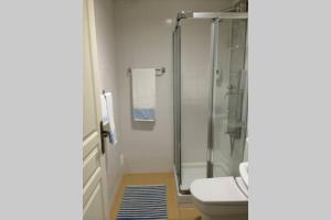 a bathroom with a glass shower and a toilet at Vacations home Albufeira in Albufeira
