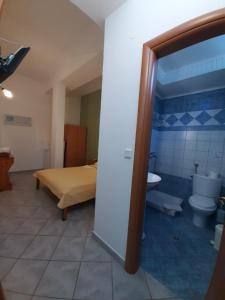 a bedroom with a bed and a bathroom with a toilet at Paraga Rooms Pefkari in Pefkari +35 photos