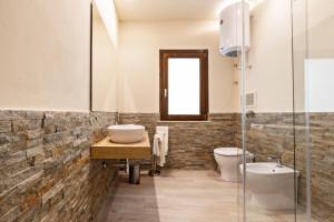 a bathroom with a sink and a toilet at Aria di Mare Apartments in Trapani +21 photos