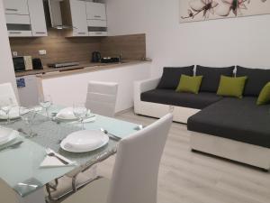 a living room with a table and a couch at OASIS APARTMAN in Szeged