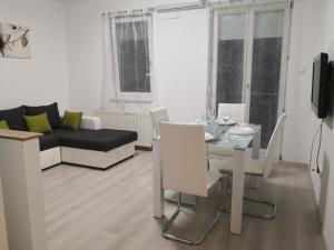 a living room with a table and a couch at OASIS APARTMAN in Szeged