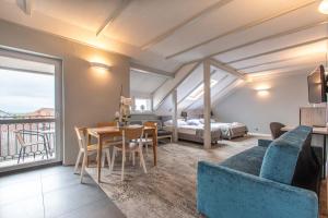 a living room with a table and a bedroom at Villa Stawros in Łeba