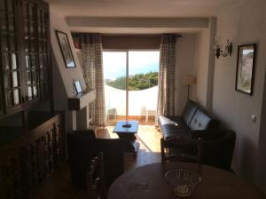 a living room with a couch and a table at Apartamentos Salema Praia Club in Salema