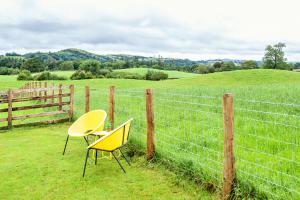 a couple of chairs sitting next to a fence at The Orchards in Kendal