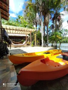 a group of kayaks parked next to the water at Chalé Marinas in Barreirinhas