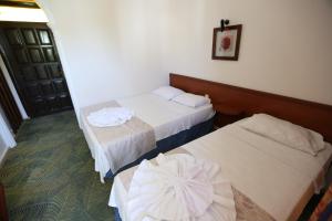 Un ou plusieurs lits dans un hébergement de l'établissement Paradise Hotel
