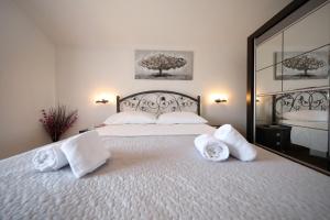 a bedroom with a large bed with towels on it at Villa Cvita in Povljana +51 photos
