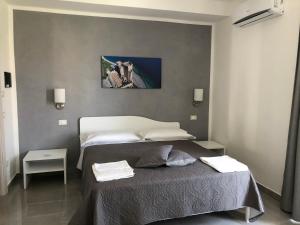 a bedroom with a bed with two towels on it at Roseto Mare B&B in Roseto Capo Spulico +20 photos
