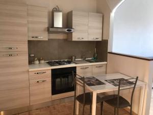 a kitchen with a table and a stove top oven at Sweet Home Sara in Ovada