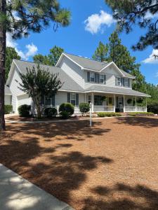 a white house with a large yard at Suite Melissa's Pinehurst Country Club #6 Private Room and Bath in Pinehurst