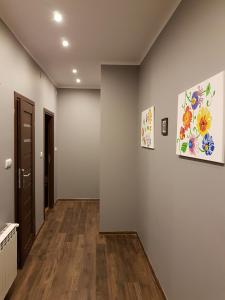 a hallway with two paintings on the walls at Center Rooms in Jarosław