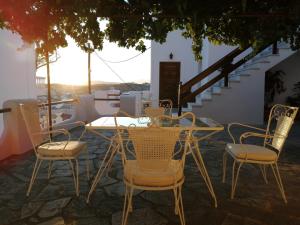 a table and chairs on a patio with a view at Sofirene Sea View in Batsi
