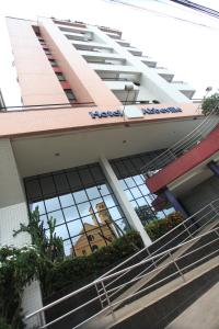 an office building with a reflection of a church in the windows at Abbeville Hotel Torre I - Torre II in São Luís