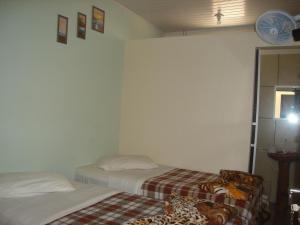 Cama ou camas em um quarto em Hotel Alvorada