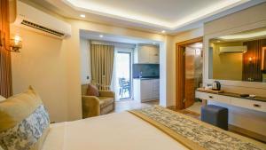 a hotel room with a bed and a living room at Green Beyza Suites in Antalya