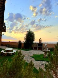 a sunset over a patio with a fountain in a yard at Sierra Palomera in Camañas