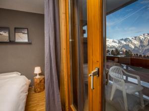 a room with a bed and a window with a view at Ravishing Apartment in La Tzoumaz in Verbier in La Tzoumaz