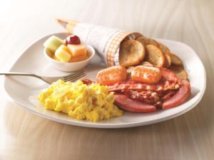 a plate of breakfast food on a table at Holiday Inn Hotel & Suites Calgary South - Conference Ctr, an IHG Hotel in Calgary