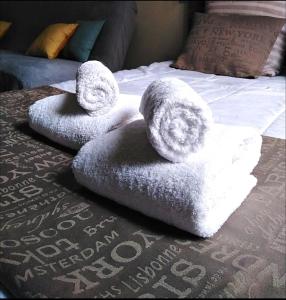 um par de toalhas sentadas em cima de uma cama em Appartement Gambetta em Pau
