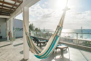 a hammock on a balcony overlooking the ocean at Villa Kite in Santa Marianita