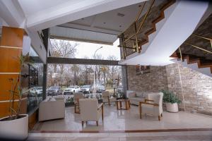 a lobby with couches and chairs in a building at Hotel Dior in Tandil