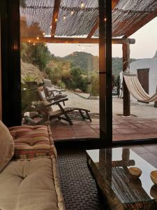 a room with a view of a patio with a hammock at Naturaleza y Arte en la Casa del Molino in Genalguacil