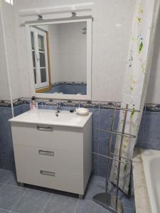 y baño con lavabo blanco y espejo. en Anduriña 2, en Monforte de Lemos