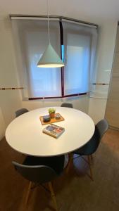 a dining room table with chairs and a lamp at Apartamento LLAR DEL CARES in Arenas de Cabrales +21 photos