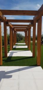 a wooden pergola in a park with grass at Olívale - Turismo Rural in Campo Maior