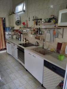 a kitchen with a sink and a counter top at Pensiunea Silvia in Baile Felix