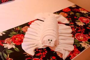 a white bird shaped object on top of a box at Pousada Málaga in Porto De Galinhas +32 photos