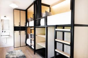a room with bunk beds and a kitchen at Modal in Greenville