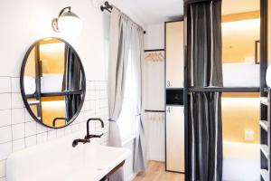 a bathroom with a sink and a mirror at Modal in Greenville