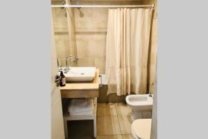 a bathroom with a sink and a toilet at Modern Studio between Palermo and Recoleta in Buenos Aires