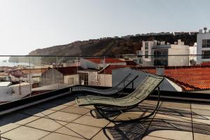 two chairs sitting on top of a roof at Sal da Terra in Nazaré