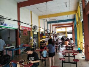 a group of people sitting at tables in a restaurant at Explore The World at The CEO Studio Penang in Bayan Lepas +23 photos