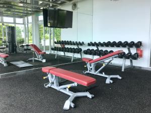 a gym with a bunch of dumbbells on a wall at Homesuite' Home at Sutera Avenue in Kota Kinabalu