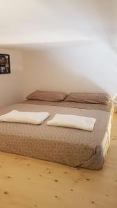 two beds in a room with two pillows on them at La casa a due passi dal mare in Marettimo