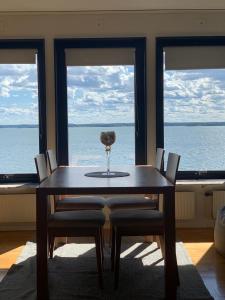 a dining room with a table and chairs with a view of the ocean at Charming house with panoramic sea view over Bråviken! in Norrköping