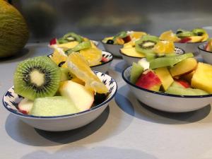 a group of bowls of fruit on a table at Het Huis van de Wadden in Den Oever