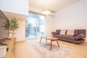 Uma área de estar em Ecru Haruyoshi Logement
