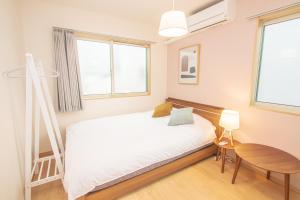 Uma cama ou camas num quarto em Ecru Haruyoshi Logement