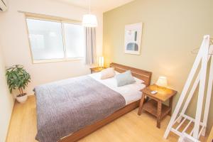 Uma cama ou camas num quarto em Ecru Haruyoshi Logement