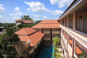 an aerial view of a building with a swimming pool at Nattidaplace Hotel Chiangmai in Chiang Mai