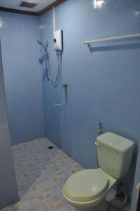 a bathroom with a toilet and a shower at Pilgrim's Kitchen & Inn in Savannakhet +48 photos