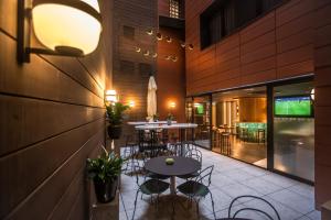 a patio with tables and chairs in a restaurant at Hotel Indigo Madrid - Gran Vía by IHG in Madrid