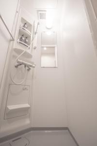 a white bathroom with a sink and a toilet at Ecru Haruyoshi Logement in Fukuoka